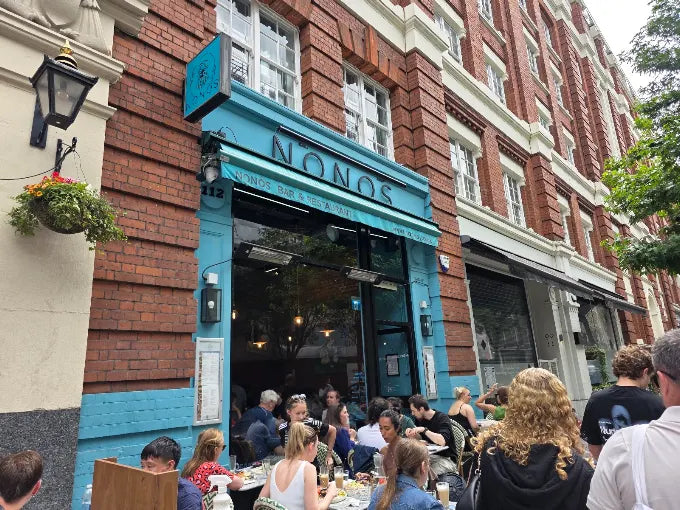 The teal Nonòs shopfront on Judd Street with guests outside