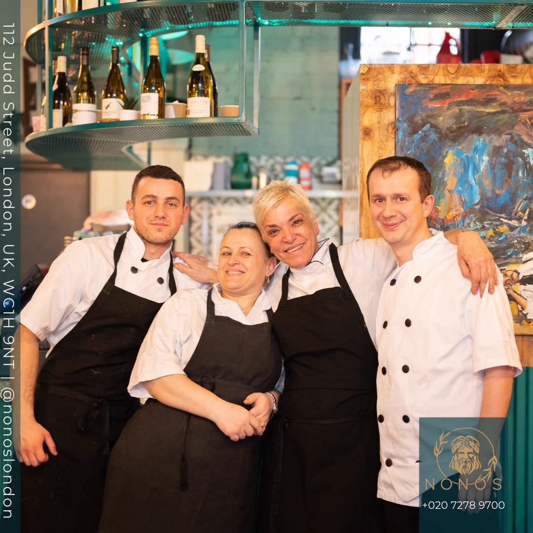Four smiling members of the Nonòs team in aprons inside the restaurant on Judd Street